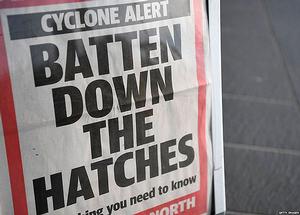 A newspaper display in Townsville. The cyclone is due to hit the mainland on Tuesday photo copyright Getty Images taken at  and featuring the  class