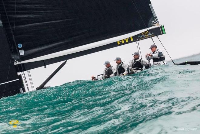 Chris Bake at the helm of Team Aqua as they disappear behind a wave - RC44 Sotogrande Cup © Martinez Studio
