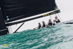 Chris Bake at the helm of Team Aqua as they disappear behind a wave - RC44 Sotogrande Cup photo copyright Martinez Studio taken at  and featuring the  class
