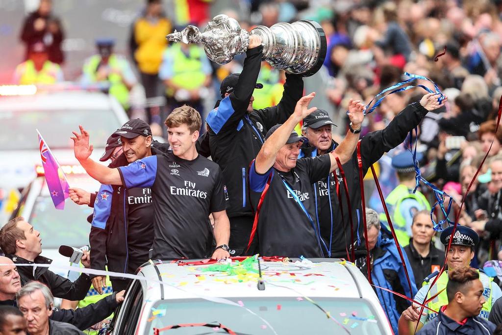  Peter Burling (L) and Grant Dalton (R) celebrate as Glenn Ashby holds the Americas Cup during the Emirates Team New Zealand Americas Cup Welcome Home Parade on July 6, 2017 in Auckland, New Zealand.  (Photo by Simon Watts/Getty Images) photo copyright Getty Images taken at  and featuring the  class