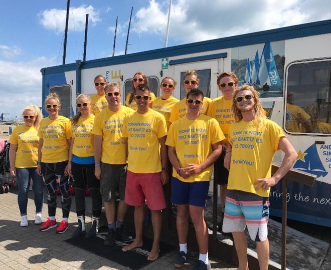 Bring me sunshine...a happy band of volunteers sporting their 'Simpson Sunnies' & bright yellow T-shirts with the all-important donation message, all ready for Lendy Cowes Week, starting this weekend. © Andrew Simpson Foundation