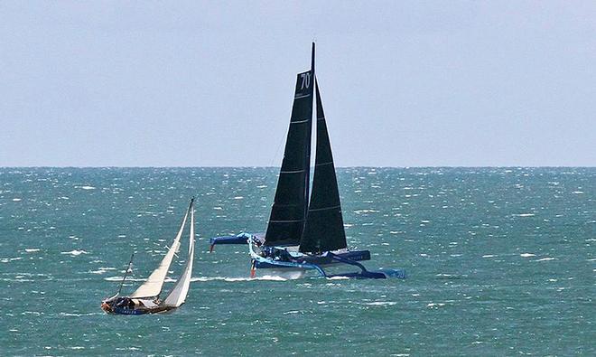 Off to Fastnet - The MOD70 Team Concise goes roaring past a boat returning to Poole after Cowes Week © Mark Jardine