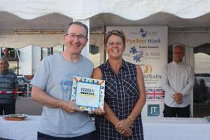 Pete Purkiss claims his RS700 prize from Sue Bouckley of Learning and Skills Solutions Pyefleet Week photo copyright  Mandy Bines taken at  and featuring the  class