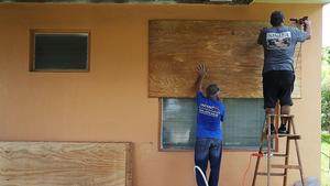 People put up shutters as they prepare a family members house for Hurricane Irma on September 6, 2017 in Miami, Florida. It's still too early to know where the direct impact of the hurricane will take place but the state of Florida is in the area of possible landfall. photo copyright Joe Raedle / Getty Images taken at  and featuring the  class