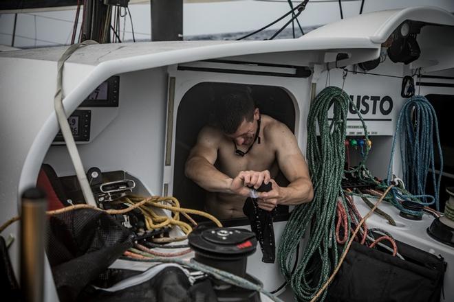 Leg 1, Day 4 – Alicante to Lisbon, onboard team Brunel. Dutch sailor Carlo Huisman tries to dry out some of his kit – Volvo Ocean Race ©  Martin Keruzore / Volvo Ocean Race