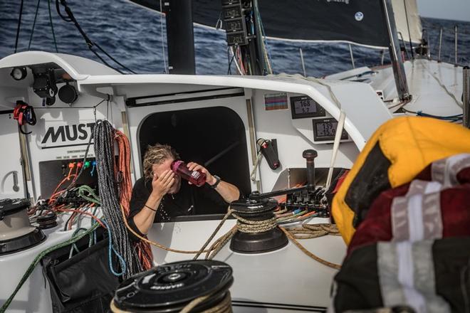 Leg 1, Day 4 – Alicante to Lisbon, onboard team Brunel. British sailor Annie Lush rinses saltwater off her face – Volvo Ocean Race ©  Martin Keruzore / Volvo Ocean Race