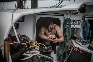 Leg 1, Day 4 – Alicante to Lisbon, onboard team Brunel. Dutch sailor Carlo Huisman tries to dry out some of his kit – Volvo Ocean Race photo copyright  Martin Keruzore / Volvo Ocean Race taken at  and featuring the  class