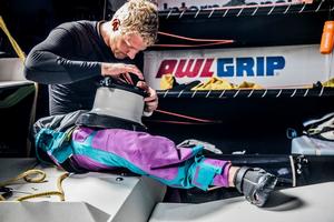 Leg 1, Day 3 – Alicante to Lisbon, onboard AkzoNobel. Danish sailor Nicolai Sehested repairs a winch – Volvo Ocean Race photo copyright  Konrad Frost / Volvo Ocean Race taken at  and featuring the  class