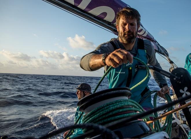 Day 10, Leg 2, Lisbon to Cape Town, on board AkzoNobel. Simeon Tienpont tidying a halyard away. Luke Molloy in background soaking up the last rays of the day. 14 November, 2017 – Volvo Ocean Race ©  James Blake / Volvo Ocean Race