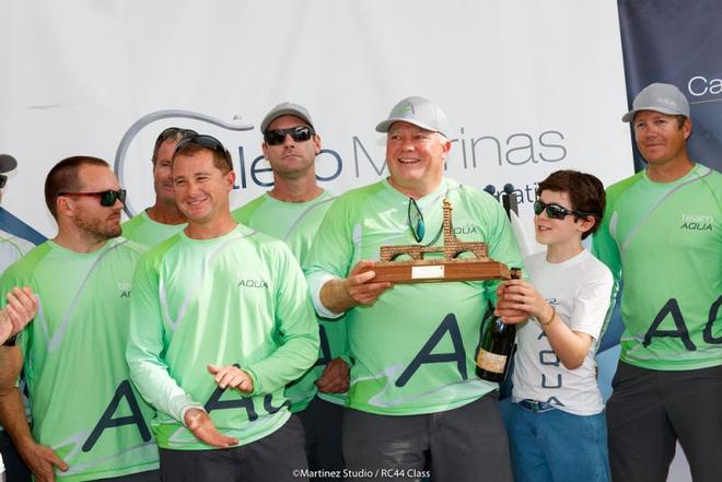 Team Aqua owner Chris Bake receives the trophy for third place at the RC44 Calero Marinas Cup ©  Martinez Studio / RC44 Class