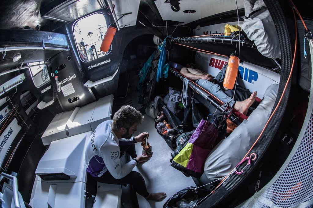 Leg 02, Lisbon to Cape Town, day 13,  on board AkzoNobel. Brad Farrand sleeps on and Simeon Tienpont munches down his supper. Photo by James Blake/Volvo Ocean Race. 17 November, 2017. ©  James Blake / Volvo Ocean Race