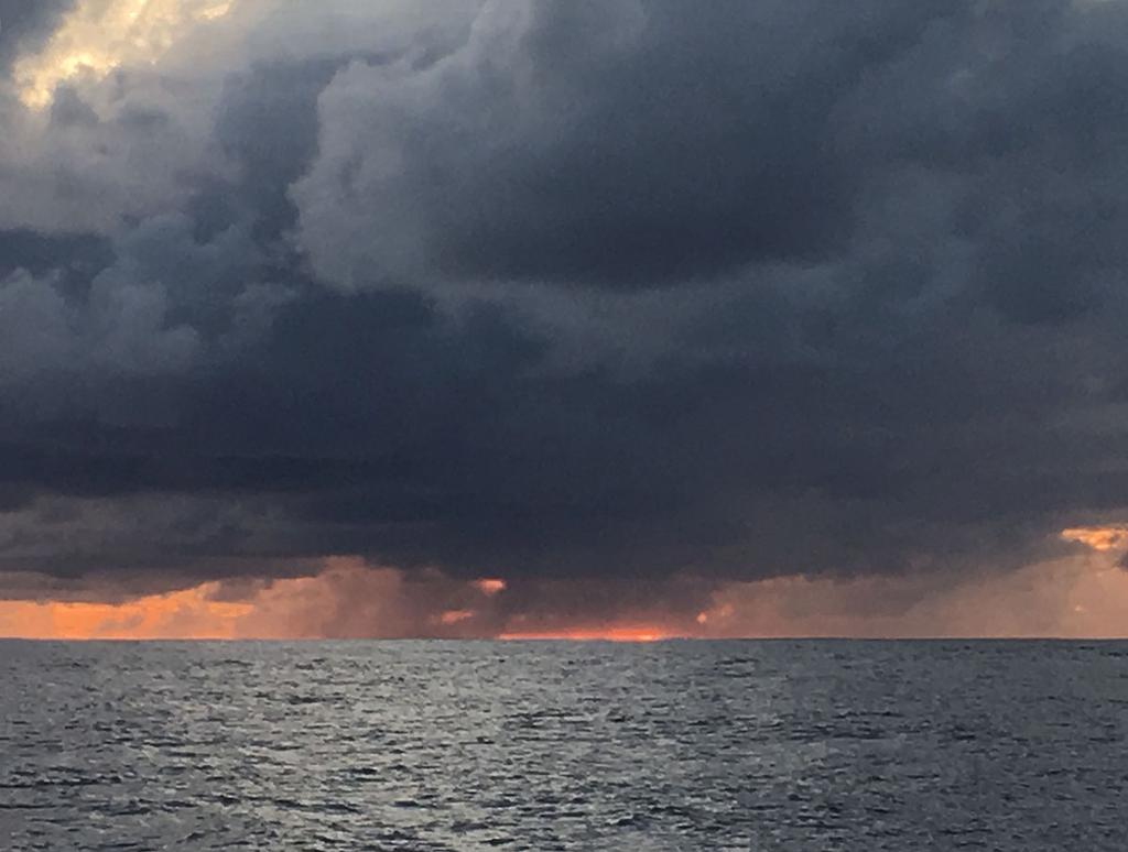 Sunset beneath storm clouds – batten down the hatches photo copyright  Kristen Anderson taken at  and featuring the  class