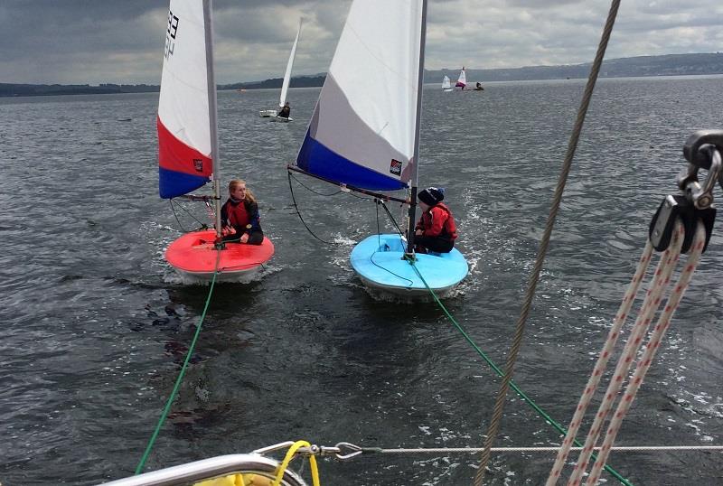 Hannah & Eilidh hitching a tow home after the Topper Scottish Championships at Helensburgh photo copyright Heather White taken at Helensburgh Sailing Club and featuring the Topper class