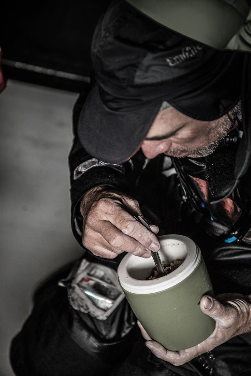 Stu Banntyne works his way through a freeze dried meal on board Dongfeng Leg 3, Day 7, Volvo Ocean Race photo copyright Martin Keruzore / Volvo Ocean Race taken at  and featuring the Volvo One-Design class