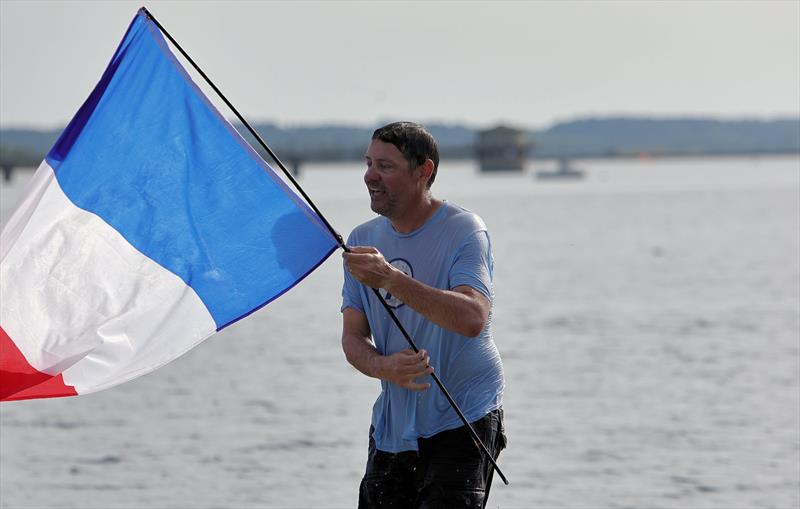 The winners celebrating with a dunk at the 2026 IOM Worlds - Alexis holding the French flag photo copyright Mark Jardine taken at Datchet Water Sailing Club and featuring the One Metre class