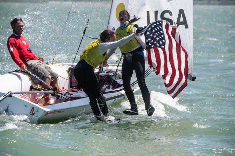 Carmen (center) and Emma Cowles (right) take a well earned plunge after winning the Girls' 420 Class gold medal at the Youth Worlds while coach Steve Keen minds the boat photo copyright Jen Edney / World Sailing taken at Corpus Christi Yacht Club and featuring the 420 class