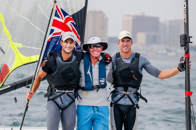 Blair Tuke (L) and Peter Burling (R) celebrate with Coach Hamish Wilcox - photo © Jesus Renedo / Sailing Energy / World Sailing