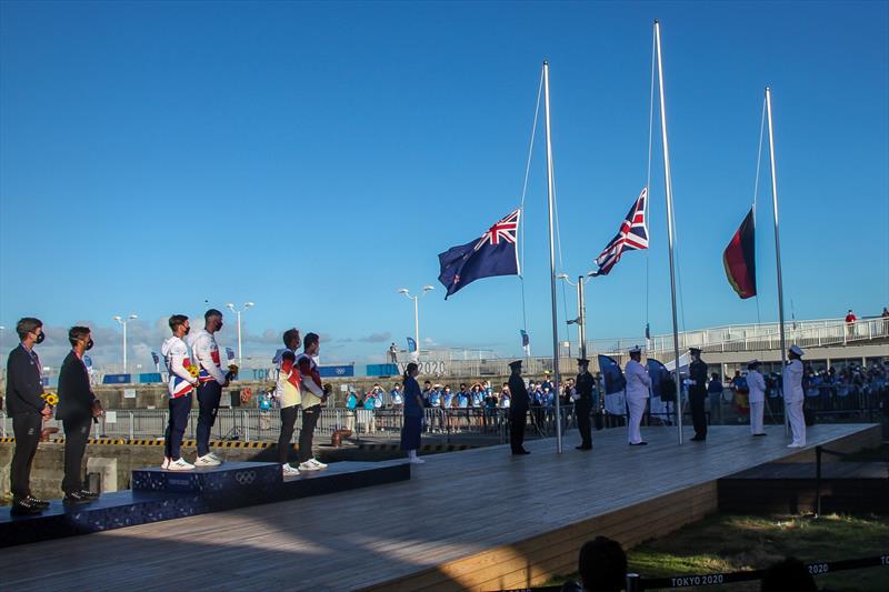 Peter Burling and Blair Tuke (NZL) watch the NZ flag being raised- 49er Medal ceremony - Tokyo2020 - Day 9- August 2, - Enoshima, Japan. - photo © Richard Gladwell - Sail-World.com / Photosport