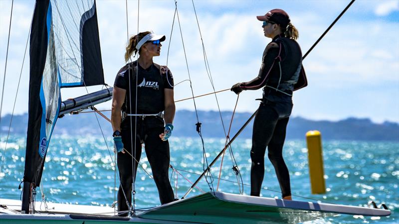 Olympic Silver medalist, Molly Meech has a quick post-race debrief with Olympic Gold and Silver Medalist, Jo Aleh - 49erFX Oceanbridge NZL Sailing Regatta - Takapuna BC February 18, 2022 - photo © Richard Gladwell / Sail-World.com / nz