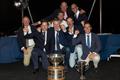 Dieter Schoen (L) and Team Momo II receive the 2025 International Six Metre Open World Championship trophies © SailingShots by Maria Muiña