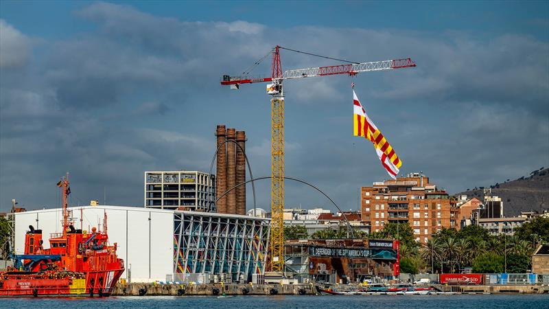 La Bandera de Barcelona the official flag of Catalonia's capital city flies from the launch crane at Emirates Team NZ's base in Barcelona - July 27, 2023 - photo © Paul Todd/America's Cup