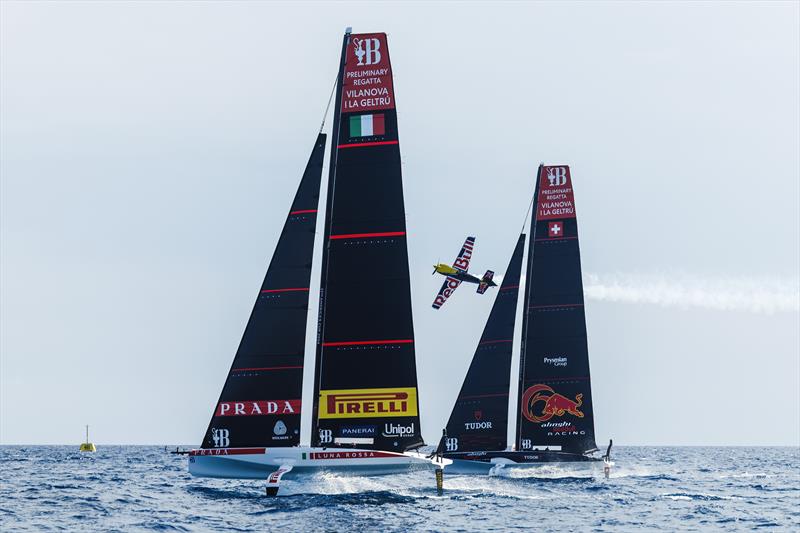 Dario Costa of Italy flies with the AC40s of Alinghi Red Bull Racing and Luna Rossa Prada Pirelli prior to the 37th Americs Cup Preliminary Regatta in Villanova photo copyright Samo Vidic / Alinghi Red Bull Racing taken at Circolo della Vela Sicilia and featuring the AC40 class