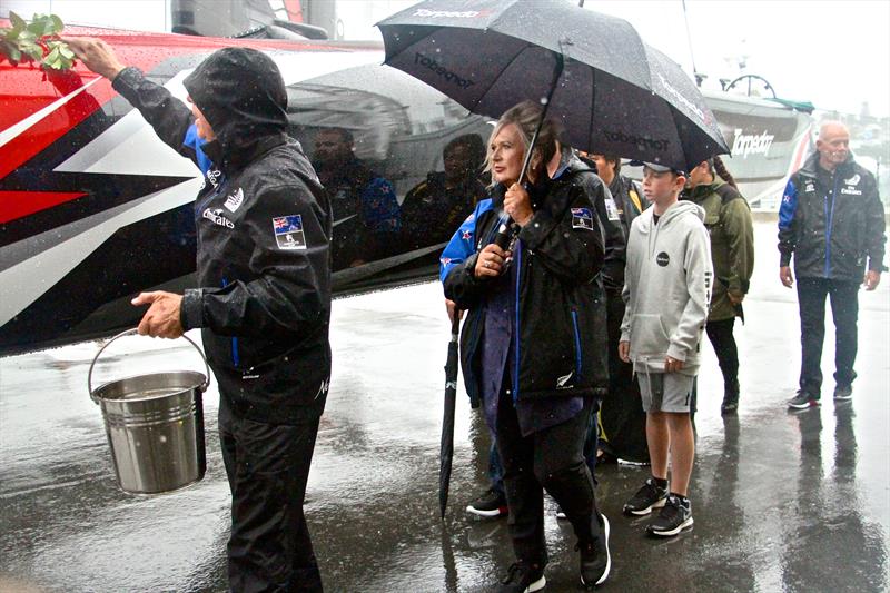 Tina Symmans holds the umbrella as Sir Stephen Tindall performs the traditional blessing of Emirates Team NZ's new AC50 and eventual Americas Cup winner. Heavy rain is always a good omen photo copyright Richard Gladwell taken at  and featuring the AC50 class