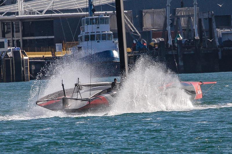 Emirates Team New Zealand tows home foils throw spray as the tow slows  - Waitemata Harbour - September 21 photo copyright Richard Gladwell taken at Royal New Zealand Yacht Squadron and featuring the AC75 class