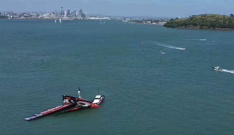 Drone shot as the tender moves into position and the designed buoyancy of the AC75 works as intended - Emirates Team New Zealand AC75, Te Aihe, capsize - December 19, 2019 photo copyright Emirates Team New Zealand taken at Royal New Zealand Yacht Squadron and featuring the AC75 class