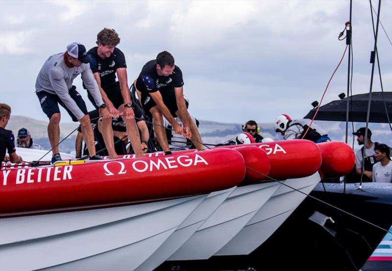 American Magic Grinder Sean Clarkson (left) works alongside ETNZ Helmsman Peter Burling and dozens of others to secure PATRIOT and prevent her from sliding further into the water photo copyright Sailing Energy / American Magic taken at  and featuring the AC75 class