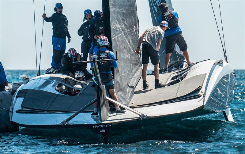 The sailing crew in position on the port-side, with a cyclor lower and facing aft, with the second pit empty  - American Magic - AC75 - Day 1 - May 7, 2024 - Barcelona - photo © Alex Carabi / America's Cup