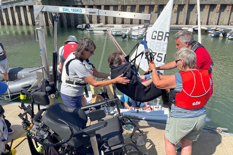 Hoisting a wheelchair user into a Hansa sailing dinghy - Disability Awareness Day in Dartmouth - photo © Dart Harbour & Navigation Authority