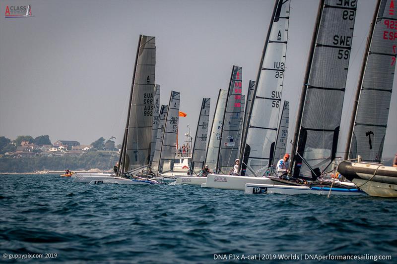 The Classic race start with Alberto Farnesi at the pin on day 2 of the A Class Cat Worlds at the WPNSA photo copyright Gordon Upton / www.guppypix.com taken at Weymouth & Portland Sailing Academy and featuring the A Class Catamaran class