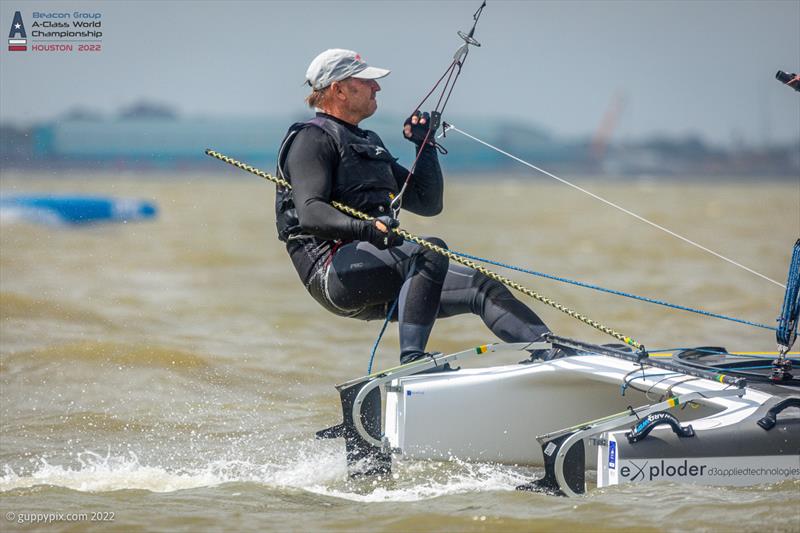 Andrew ‘Landy' Landenberger locked in to his boat during a rough downwind leg on day 3 of the Beacon Group A-Class Catamaran World Championships in Texas photo copyright Gordon Upton / www.guppypix.com taken at Houston Yacht Club and featuring the A Class Catamaran class