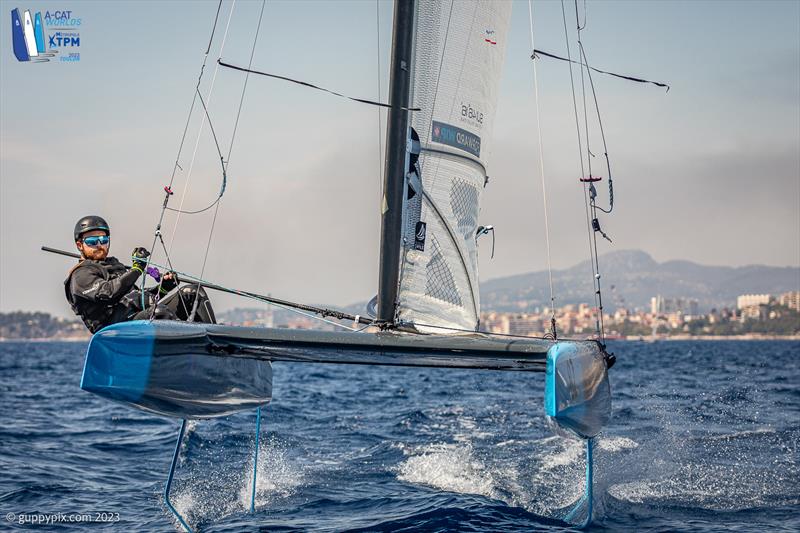 A-Cat Worlds at Toulon, France Day 2 - Swiss Champ, Robin Maeder SUI 7, entertains the media crew whilst that minesweeper goes through - photo © Gordon Upton / www.guppypix.com