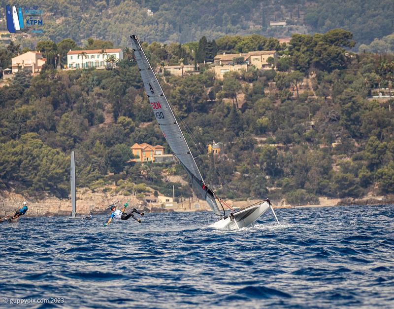 A-Cat Worlds at Toulon, France Day 5 - The unfortunate Viking Warrior Jan takes a trip around the mast on a wavy downwind leg photo copyright Gordon Upton / www.guppypix.com taken at Yacht Club de Toulon and featuring the A Class Catamaran class