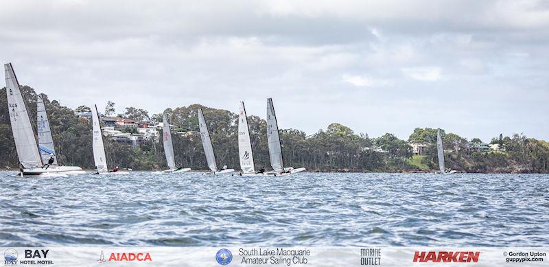 Australian A-Cat Nationals on Lake Macquarie Day 2 - The start of the last open race, Ravi Parent gets a blistering start after spotting something missed by the rest photo copyright Gordon Upton / www.guppypix.com taken at South Lake Macquarie Amateur Sailing Club and featuring the A Class Catamaran class