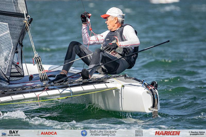 Australian A-Cat Nationals on Lake Macquarie Day 3 - Reigning World Classic Champion, Scott Anderson, fends off a strong challenge from his fellow old Olympian Landy in the Classic fleet photo copyright Gordon Upton / www.guppypix.com taken at South Lake Macquarie Amateur Sailing Club and featuring the A Class Catamaran class