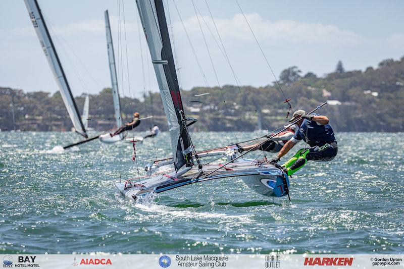 Australian A-Cat Nationals on Lake Macquarie Day 5 - Dom Tanner demonstrates his flexibility on his lovely blue DNA F1x - photo © Gordon Upton / www.guppypix.com