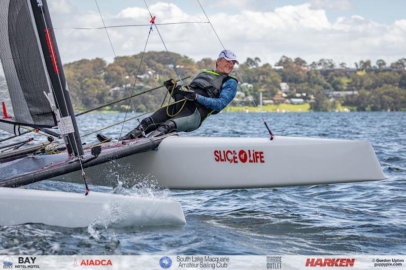 Australian A-Cat Nationals on Lake Macquarie Day 5 - Dave Richardson just happy to be sailing his lovely 15 year old Geltek Flyer photo copyright Gordon Upton / www.guppypix.com taken at South Lake Macquarie Amateur Sailing Club and featuring the A Class Catamaran class