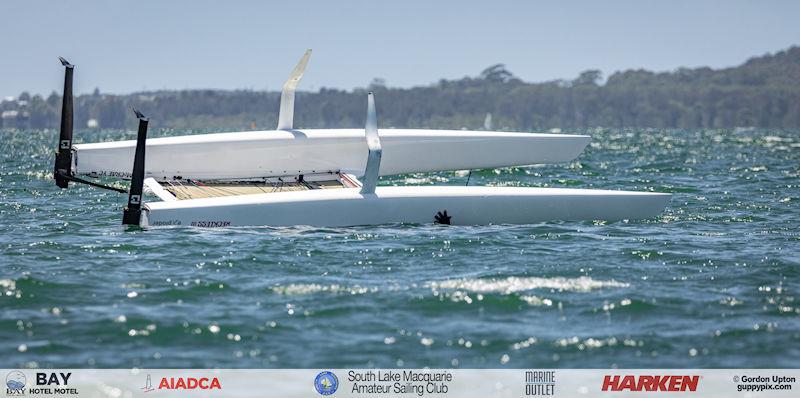 Australian A-Cat Nationals on Lake Macquarie Day 5 - Yes, that is Hamish's hand... all was fine after he freed the boat mast from the lake bottom photo copyright Gordon Upton / www.guppypix.com taken at South Lake Macquarie Amateur Sailing Club and featuring the A Class Catamaran class