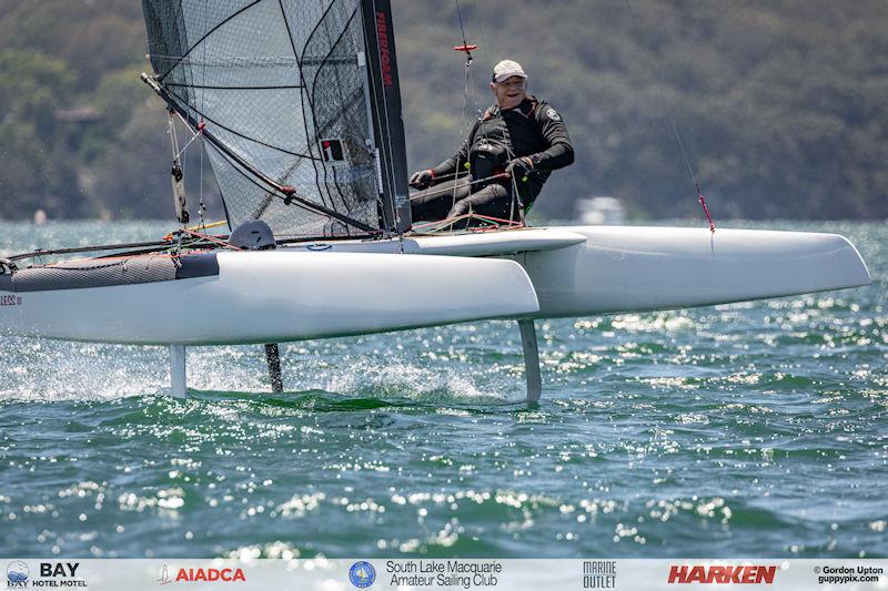 Australian A-Cat Nationals on Lake Macquarie Day 5 - Happy times for Hamish Sinclair photo copyright Gordon Upton / www.guppypix.com taken at South Lake Macquarie Amateur Sailing Club and featuring the A Class Catamaran class
