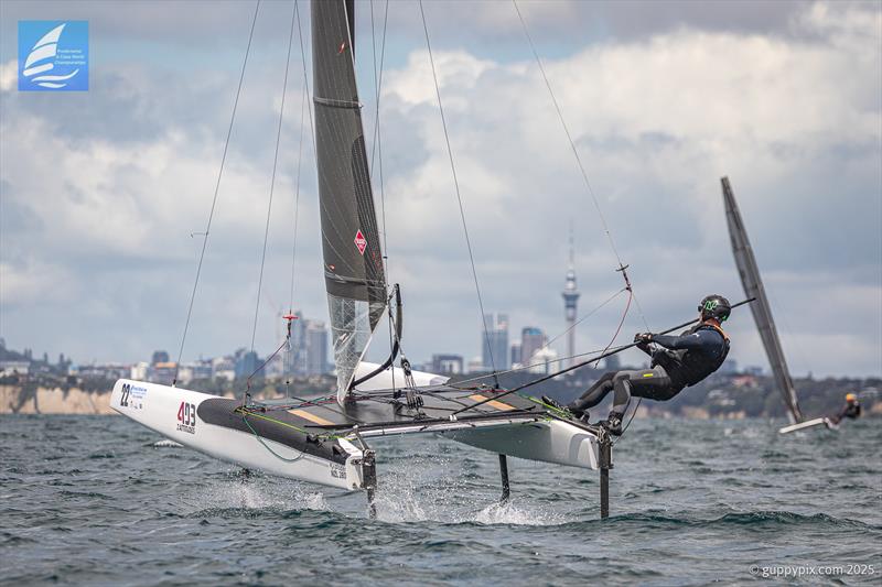 PredictWind A-Class Cat Worlds 2025 - Local sailor Andrew Johnson NZL 280, with his local landmark - photo © Gordon Upton / www.guppypix.com