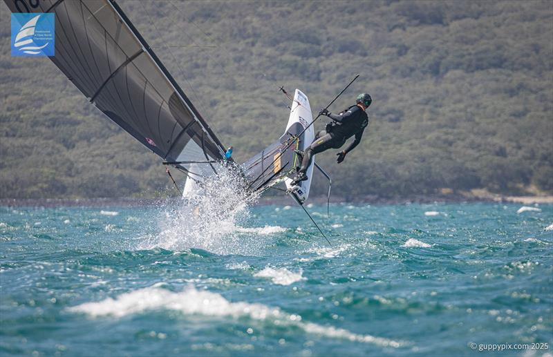 PredictWind A-Class Cat Worlds 2025 Day 4 - Aussie sailor Andrew Johnson gets rather loose on the downwind bear-away, but did tame the thing in this case photo copyright Gordon Upton / www.guppypix.com taken at Milford Cruising Club and featuring the A Class Catamaran class