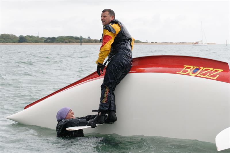 Nathan Stanier standing on his centreboard during the Buzz Nationals at Warsash photo copyright Iain McLuckie taken at Warsash Sailing Club and featuring the Buzz class