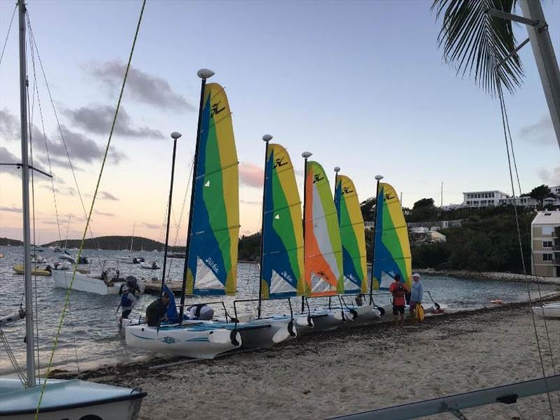 Hobie Waves lined up on the beach in front of the St. Thomas Yacht Club, U.S. Virgin Islands photo copyright St. Thomas Sailing Center taken at St. Thomas Yacht Club and featuring the Catamaran class