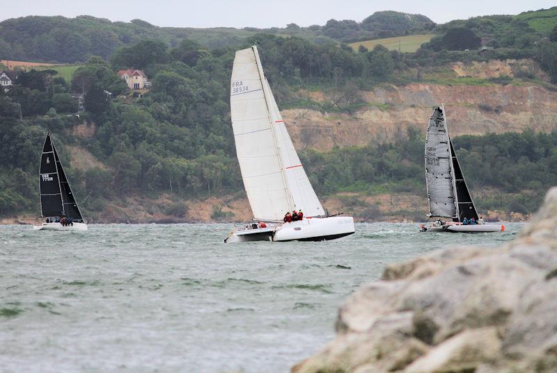 The 2023 Round the Island Race fleet pass through the Hurst narrows photo copyright Sam Jardine taken at Island Sailing Club, Cowes and featuring the Catamaran class