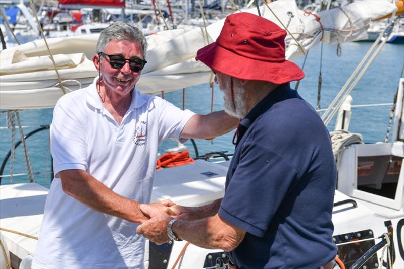 Pascal Pellouin, skipper of Bernard Moitessier's famous yacht Joshua is welcomed by Sir Robin Knox-Johnston aboard his yacht Suhaili in Les Sables d'Olonne photo copyright Christophe Favreau / PPL / GGR taken at  and featuring the Classic Yachts class