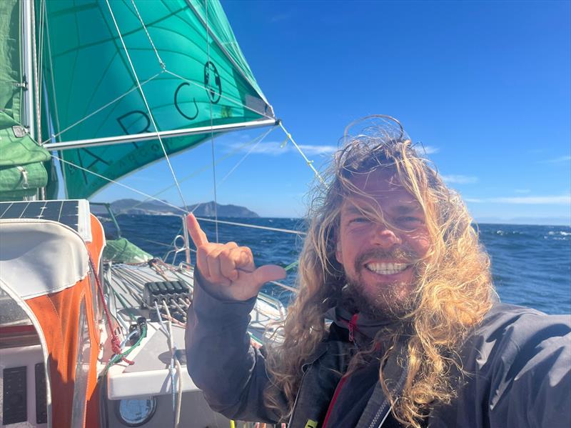 An ebullient Christian Sauer sailing ARGO past the Cape of Good Hope, with three oceans in the wake photo copyright Christian Sauer / MGR2025 taken at  and featuring the Class Mini 5.80 class