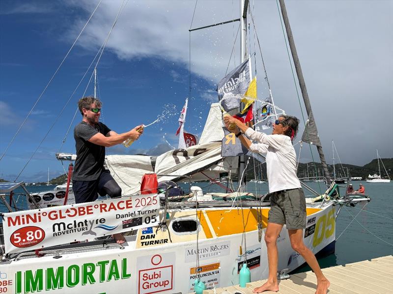 Dan and Pilar celebrating their finishes in the Mini Globe Race photo copyright Susan Harrison taken at  and featuring the Class Mini 5.80 class